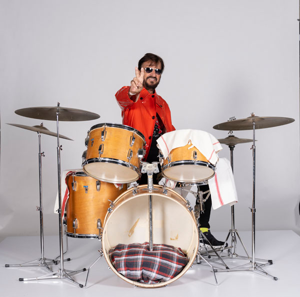 Ringo wearing the red vinyl rooftop Apple Studios raincoat behind his 1967 Ludwig Hollywood drum kit